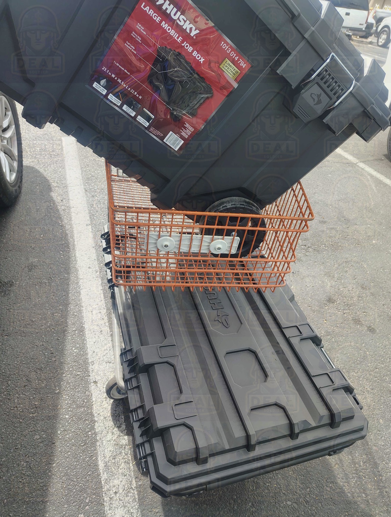 Husky Large Mobile Job Box stacked on a Husky Medium Rolling Toolbox on an orange Home Depot flat cart in the parking lot.